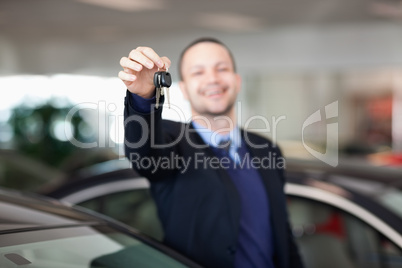Man standing while holding car keys