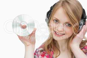Woman holding a cd while looking at camera
