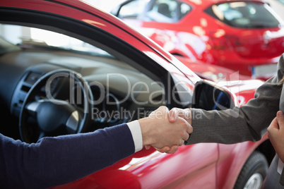 Close up of a man shaking hand to a woman