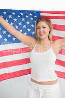 Happy blonde woman holding the Old Glory flag