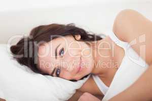 Smiling brunette woman waking up