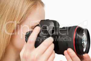 Close up of a young woman holding a camera