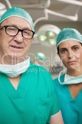 Surgeon with glasses on and a colleague