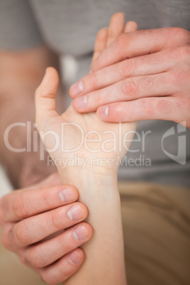 Doctor looking at the wrist of a patient