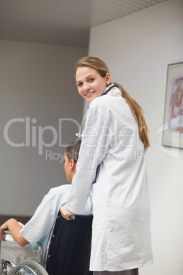 Smiling doctor pushing a wheelchair