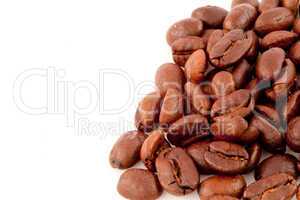 Many dark blurred coffee seeds laid out together