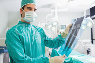 Surgeon standing while holding a X-ray