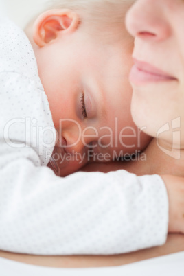 Baby napping on the chest of her mother