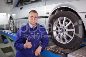 Man smiling next to a car