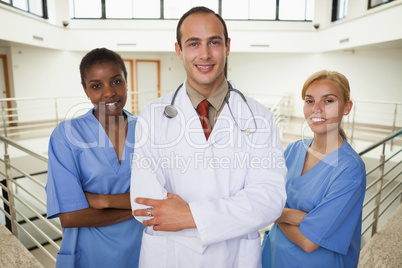 Smiling doctor and nurses looking at camera
