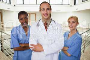 Smiling doctor and nurses looking at camera