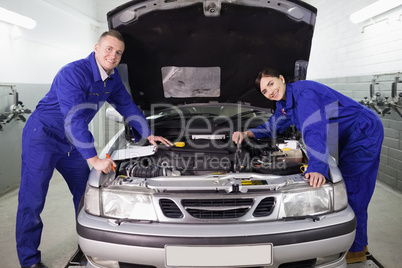 Mechanics leaning on a car