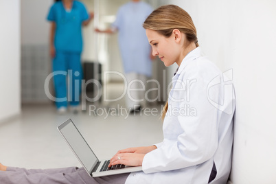Woman lying on the floor with a laptop