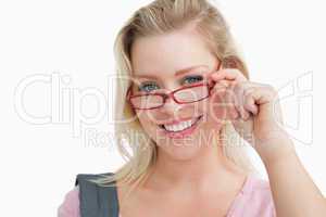 Happy young woman holding red glasses