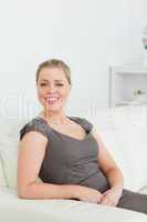 Woman smiling while sitting on a sofa