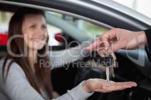 Happy woman receiving car keys