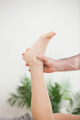 Doctor holding the foot of his patient