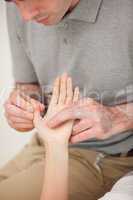 Man massaging the thumb of a woman