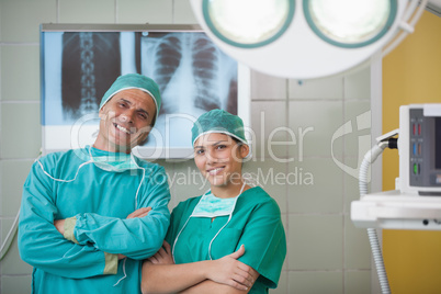 Surgeon and a nurse looking at camera