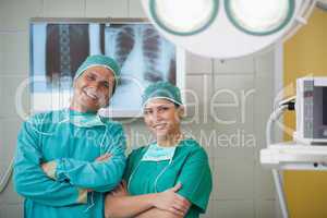 Surgeon and a nurse looking at camera