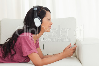Cute Latino listening to music with her smartphone