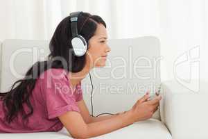 Cute Latino listening to music with her smartphone