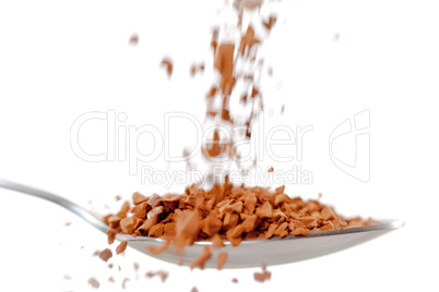 Chocolate powder falling in a spoon