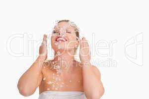 Blonde woman splashing her face