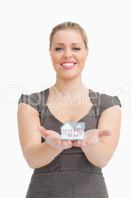 Smiling woman showing a model house