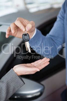 Man giving keys to a woman