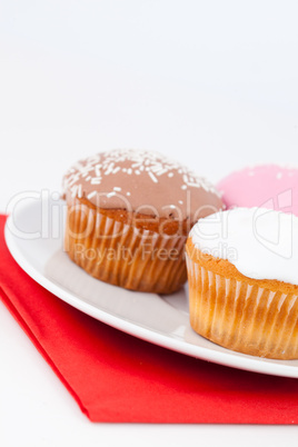 Three cupcakes on a white plate
