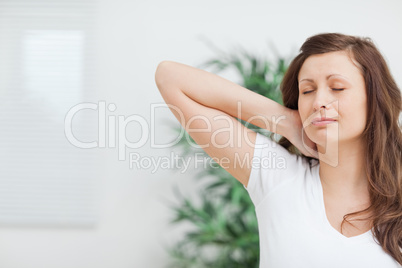 Woman placing her hand on her painful neck