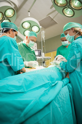 Medical team operating a patient
