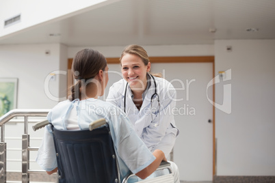 Doctor in front of a patient on a wheelchair