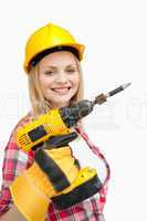 Woman smiling while holding an electric screwdriver
