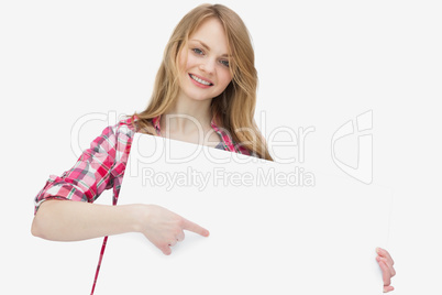 Woman looking at camera while showing a blank board Woman looking at camera while showing a blank board