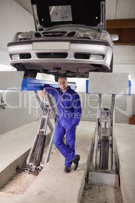 Smiling man leaning on a machine