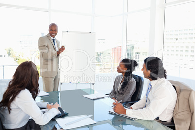 Businessman giving a presentation in front of his colleagues