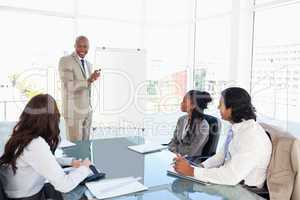 Businessman giving a presentation in front of his colleagues