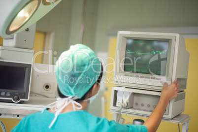 Surgeon checking a monitor