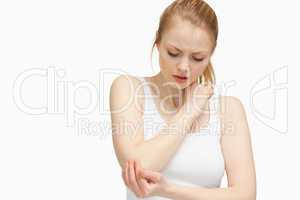 Young woman touching her elbow