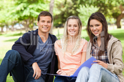 Portrait of three teenagers studying together