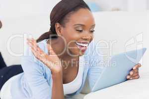 Black woman holding a tablet computer