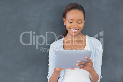 Front view of a black woman holding a tablet computer