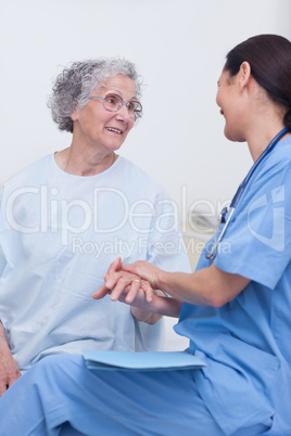 Nurse and a patient sitting on a bed