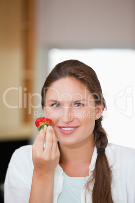 Woman eating a strawberry