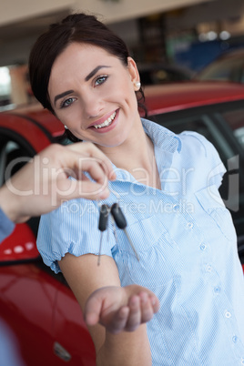 Woman smiling and receiving car keys