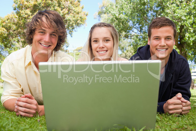 Close-up of three happy students in a park
