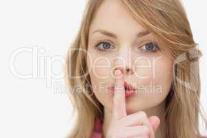 Woman putting a finger in front of her mouth