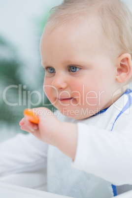 Baby holding a plastic spoon